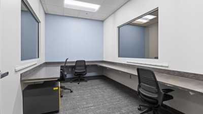 a lab room with two-way mirrors and a ledge around the space.