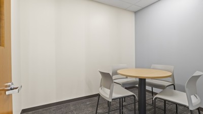 a room with a small round table and chairs.
