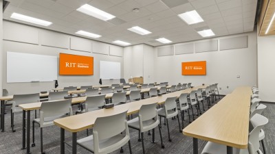 large classroom with long tables and chairs.