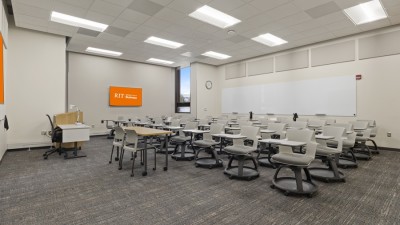 a large classroom space with individual desks and chairs. 