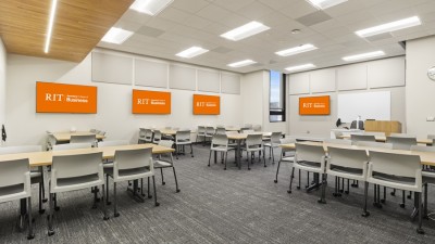 a large classroom space with tables and chairs on wheels.