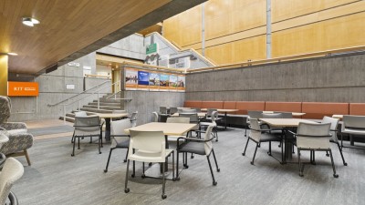 a sunken lounge area with several tables and chairs.