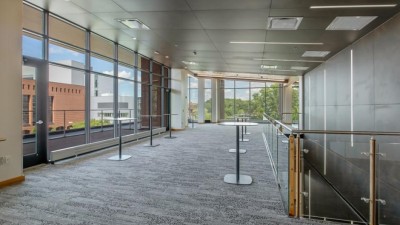 a large, carpeted reception area with high top tables.