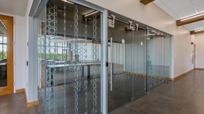 a glass room with holders for wine bottles.