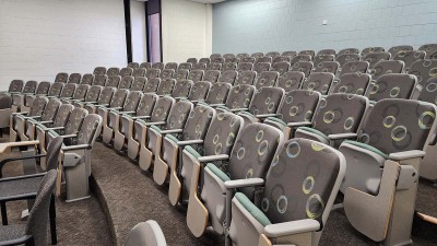several rows of empty auditorium seating.