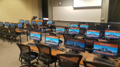 RIT screen savers on in a computer lab with a large whiteboard in the front of the room