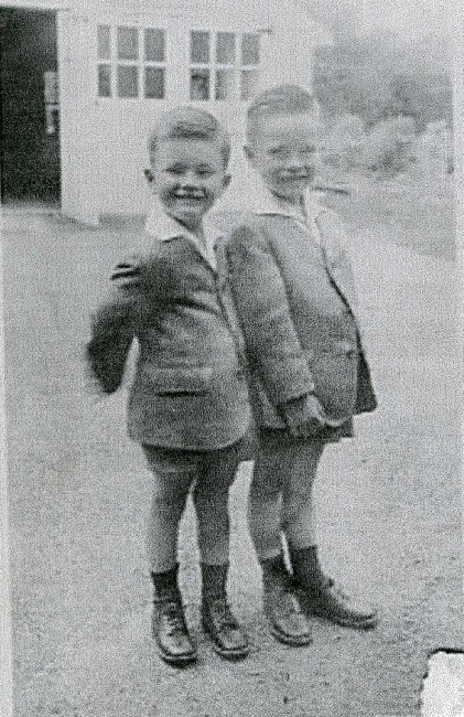 Young E. Philip Saunders standing with a friend