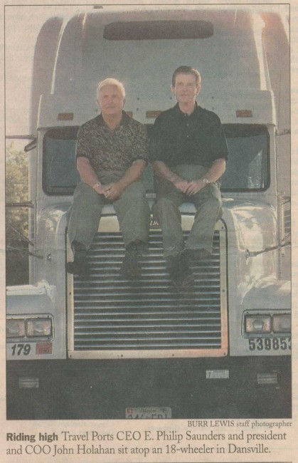 Newspaper photo of Mr. Saunders sitting on a large truck