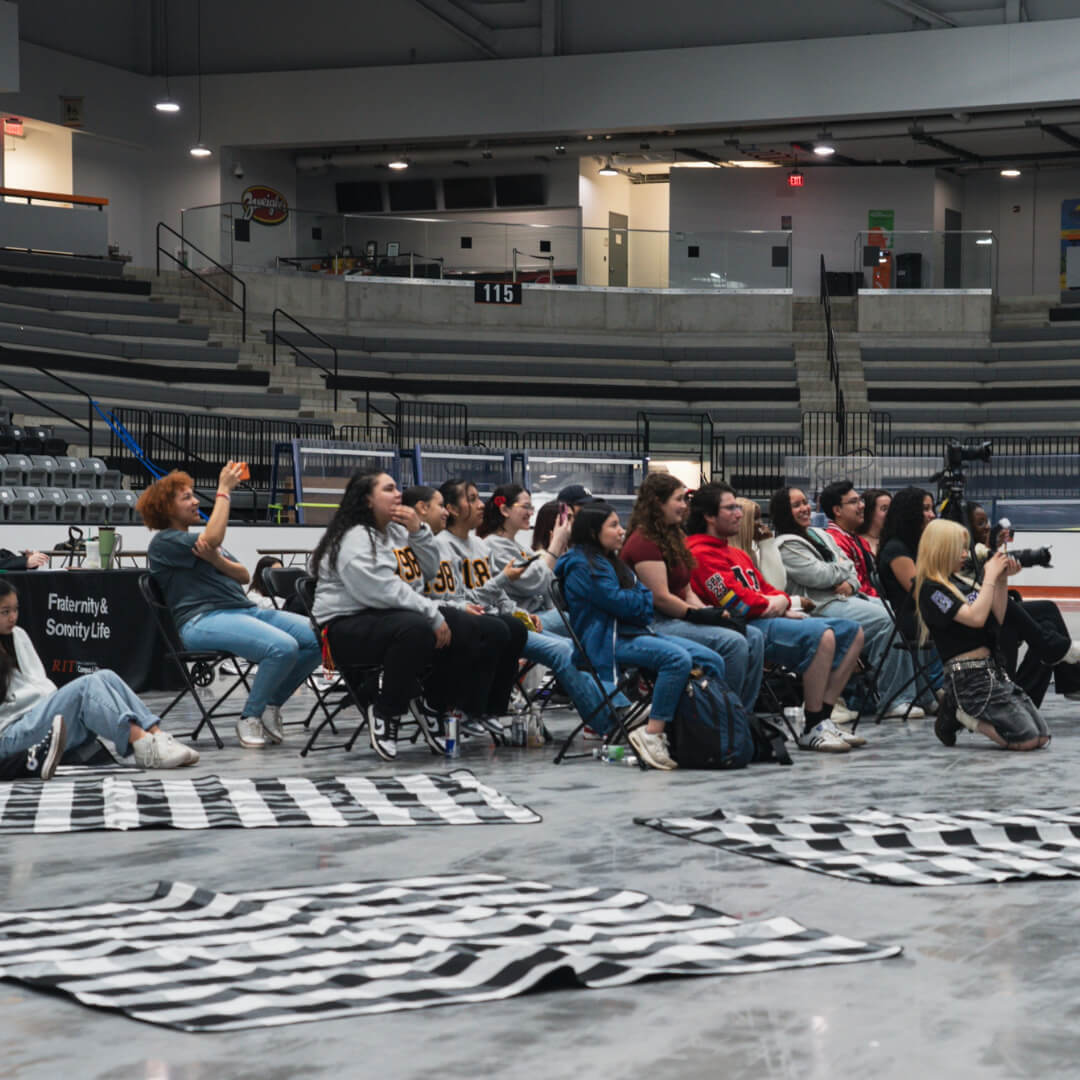 Students watching the Multicultural Greek Council Yard Show during Greek Week