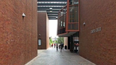 bricked pathway between two brick buildings.