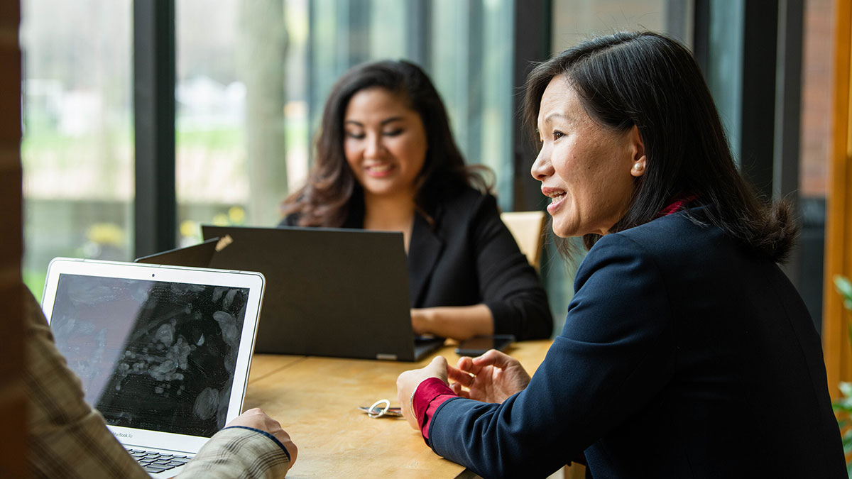 two women in business attire having a meeting.