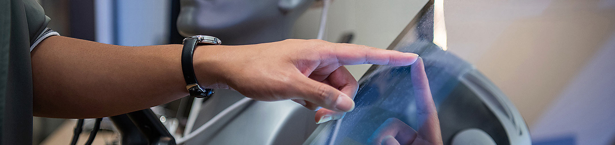 A close up of a person touching a computer screen.