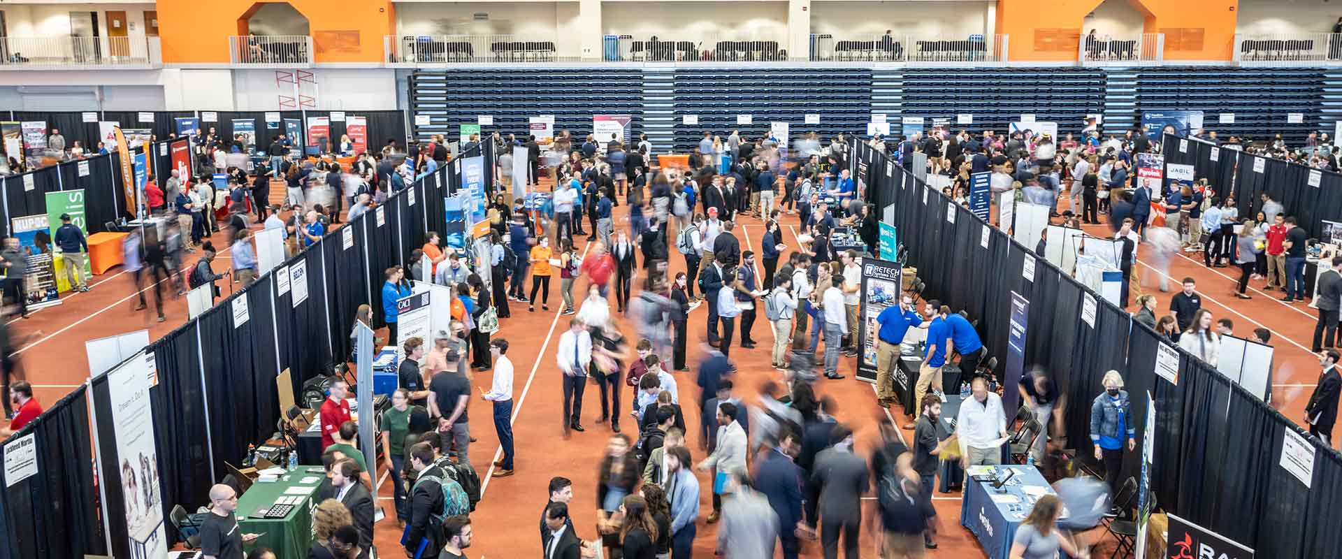 An aerial view of RIT students inside the career fair, meeting with company representatives.