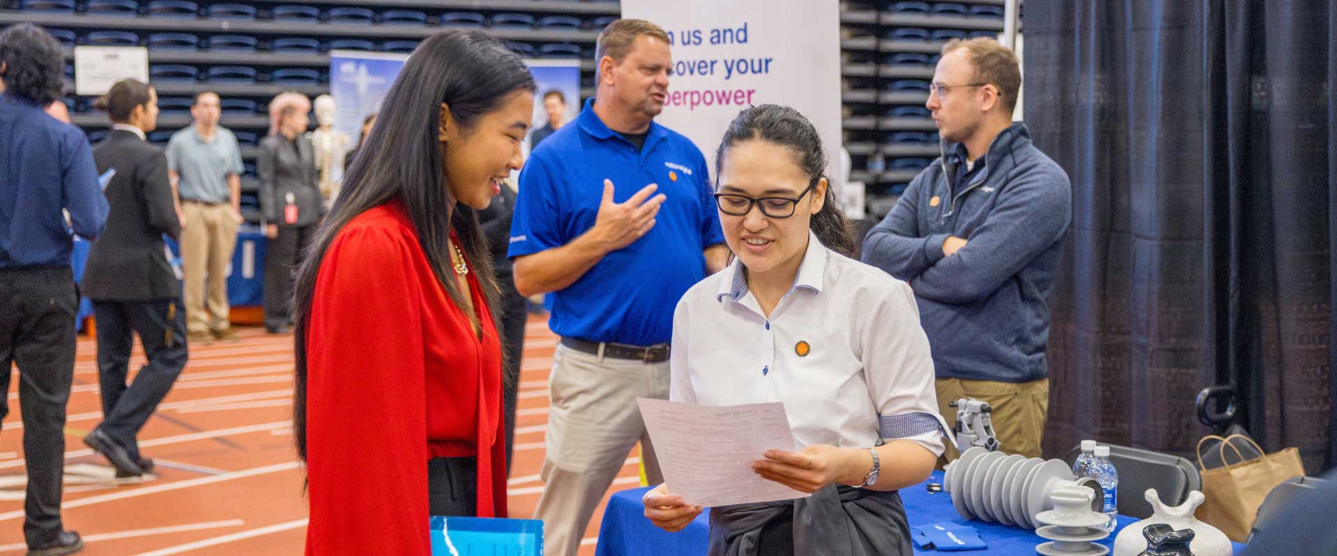 a student and a recruiter review a resume at R I T's fall career fair.