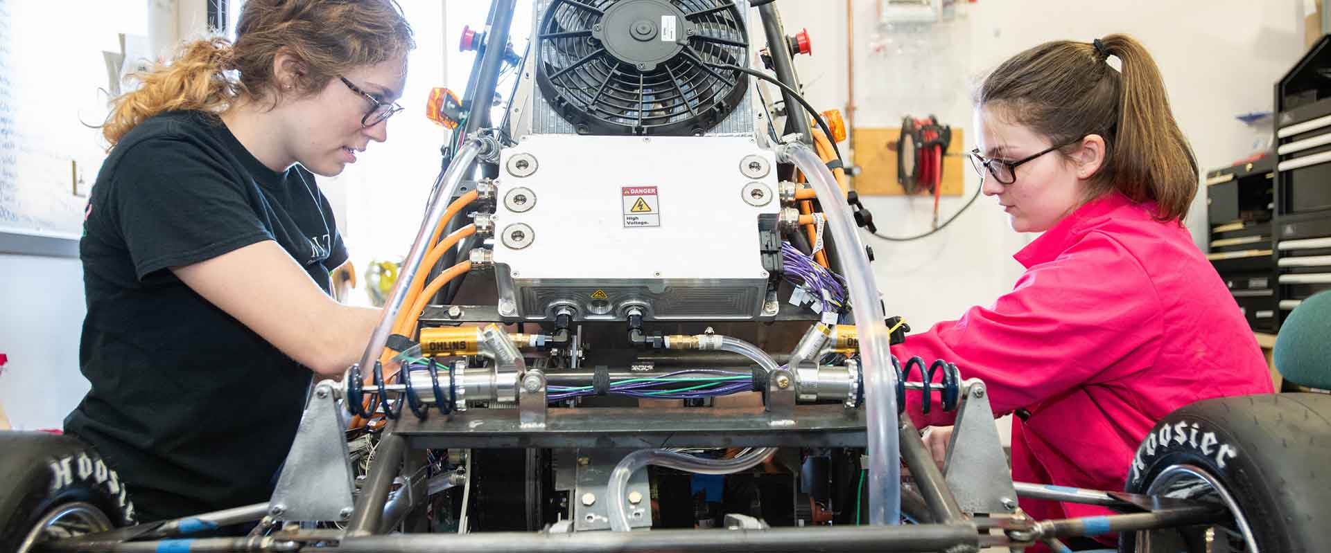 Two members of the RIT Hot Wheelz club working on their car.
