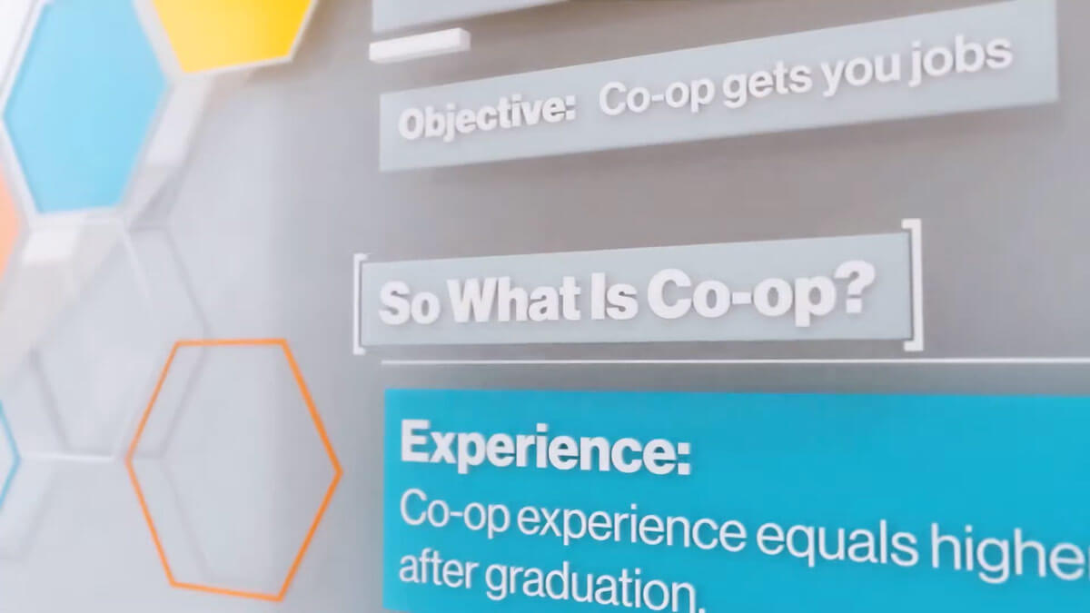 A screenshot from a video showing hexagons on the left and text on the right saying: "What is Co-op?"
