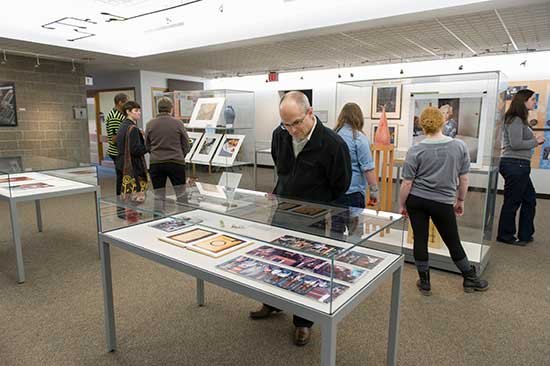 Patrons looking at exhibits in a gallery