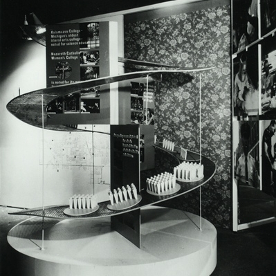 Photograph.  Spectators viewing “working conditions in Kalamazoo” at Kalamazoo...and how it grew! exhibit, shown throughout England, 1958.  Photographer: Gordon McLeish and Associates.