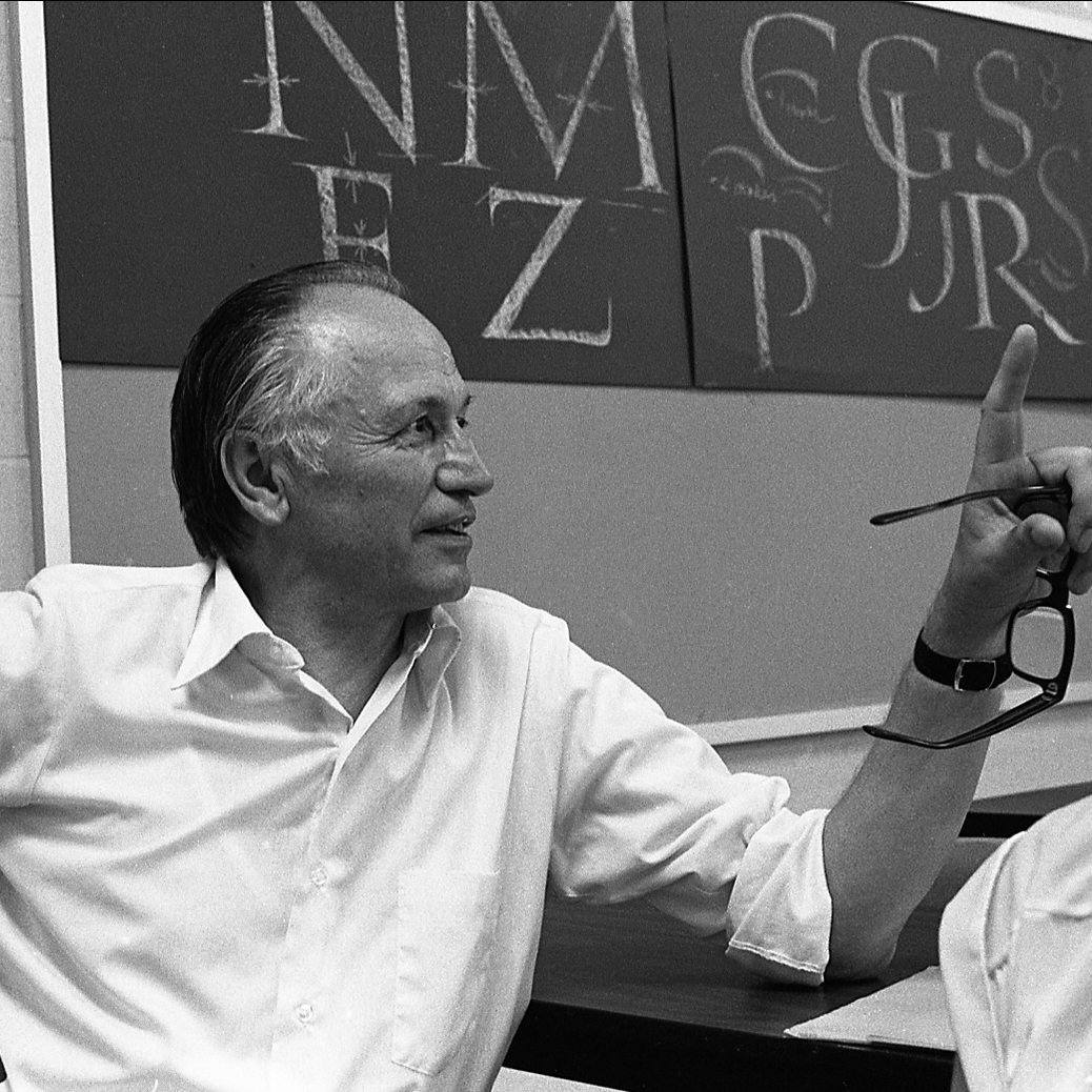 Zapf in classroom with calligraphy teaching sheets.