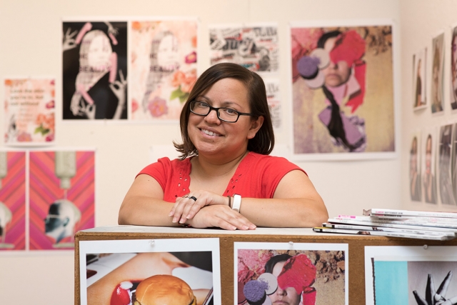 Student poses with images of artwork.