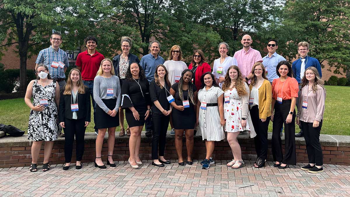 a large group of faculty members and researchers posing outdoors.
