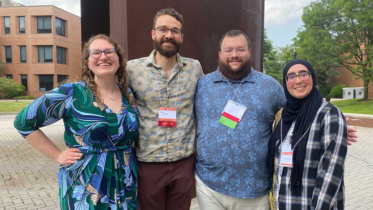 four faculty researchers posing for a photo outdoors.