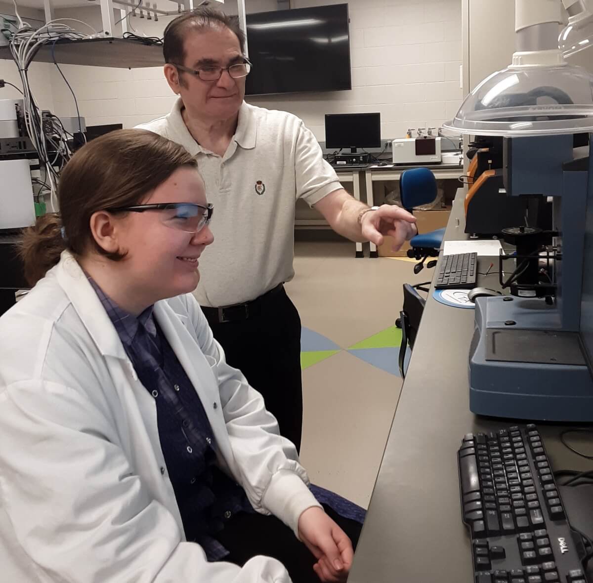 Amina Andelija and Dr. Matt Miri in a research lab.