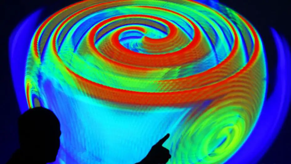 A computer simulation of red, blue, and green spirals emitting from a central source.