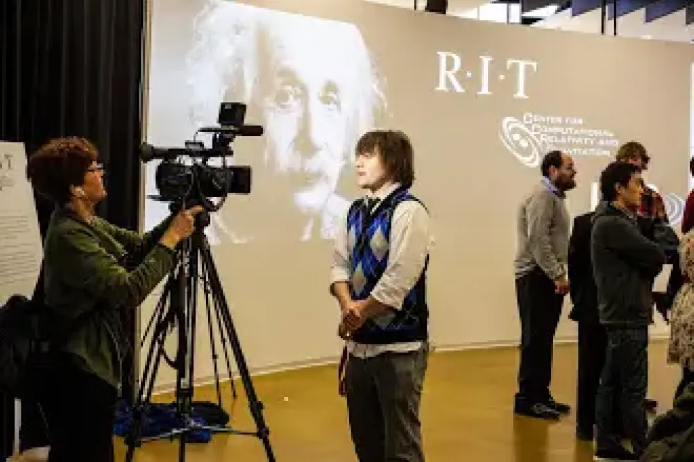 A person gives an interview on camera at an event.