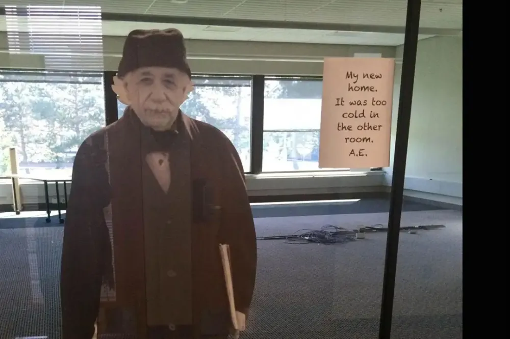 A cardboard cutout of Albert Einstein in an empty room.
