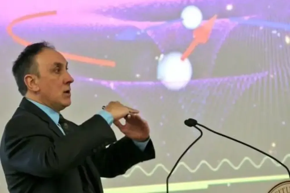 An R I T professor speaking at a podium.
