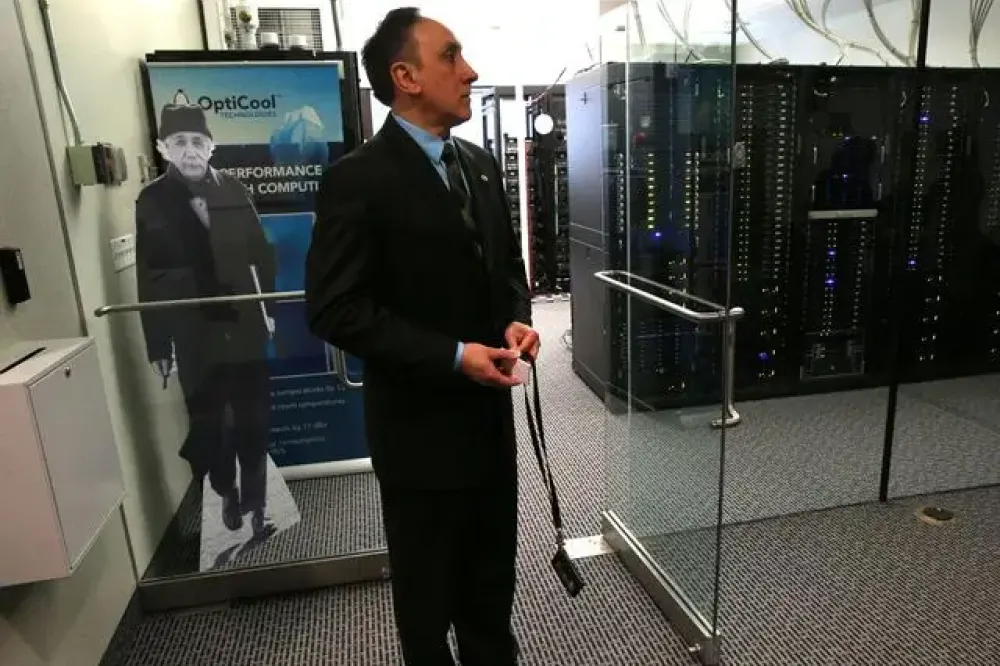 A researcher stands just outside the server room.