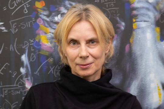a headshot of Manuela Campanelli with a chalkboard in the background