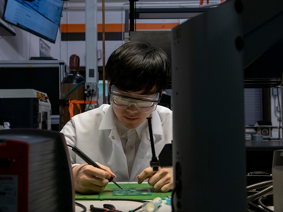 Student hand-soldering a circuit board