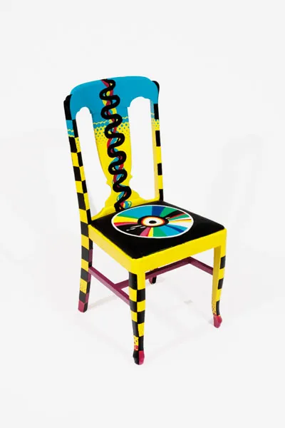 A vibrantly-painted chair featuring the image of a CD, along with sound waves and a halftone effect to evoke a feeling of Y2K / vaporwave nostalgia.