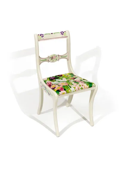 Refinished chair features a soft, creamy white frame, with accents of flowers and butterflies throughout. Also possesses a vibrant floral seat bursting with color.