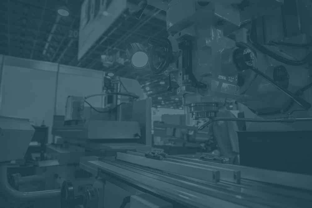faded dark blue image of industrial automation in factory setting