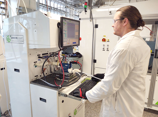 researcher at machine in fuel cell testbed