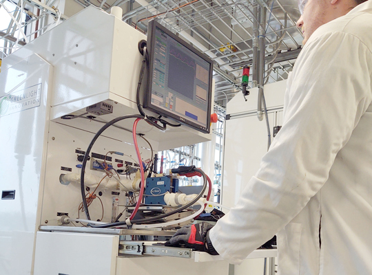researcher working on device in fuell cell lab