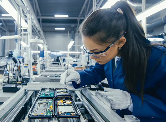 Electronics Factory Worker Assembling Circuit Boards by Hand