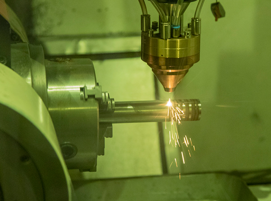 laser additive repair machine working on a piece of metal