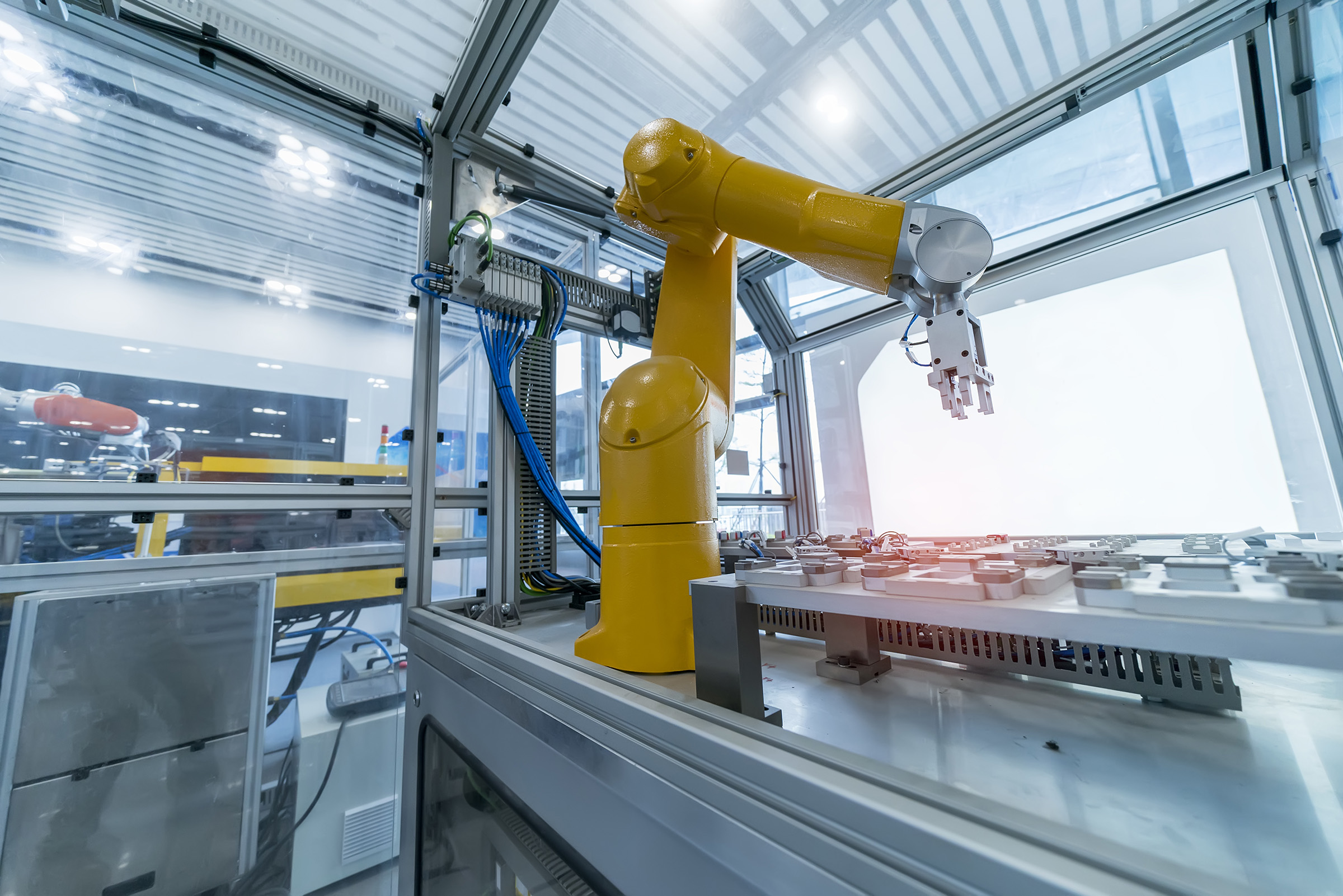 Large yellow smart production robot arm in factory setting