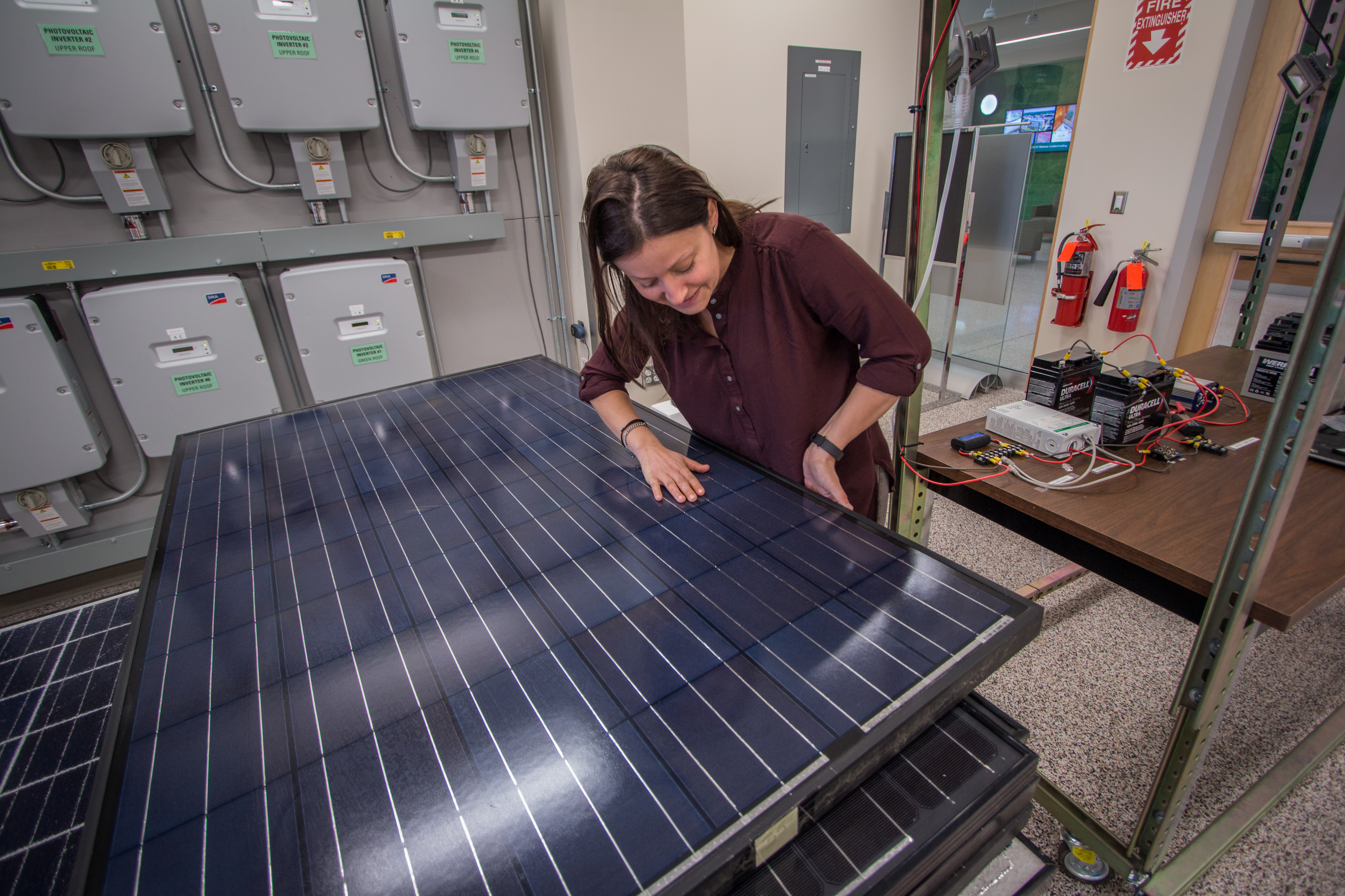 female researcher working on solar panels in lab
