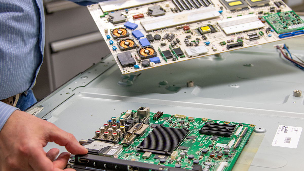 A technician handling circuit boards.