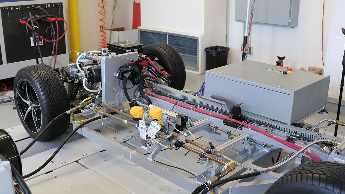 A vehicle chassis mounted on a testing rig.