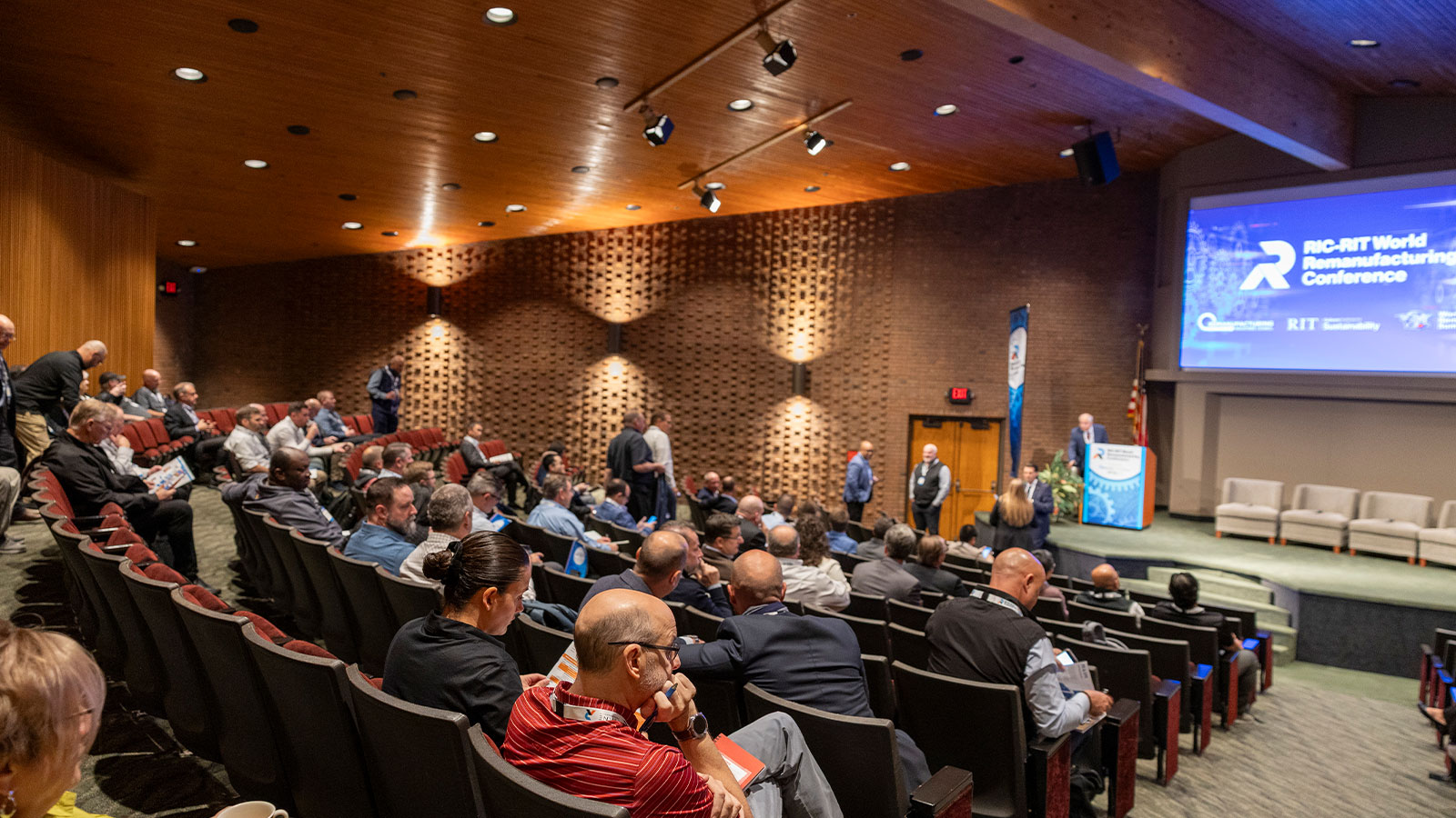 auditorium full of people looking at a stage at the 2025 World Reman Conference