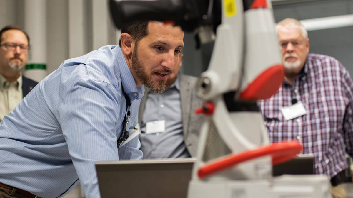 An RIT staff member showing off equipment at a Remade event.