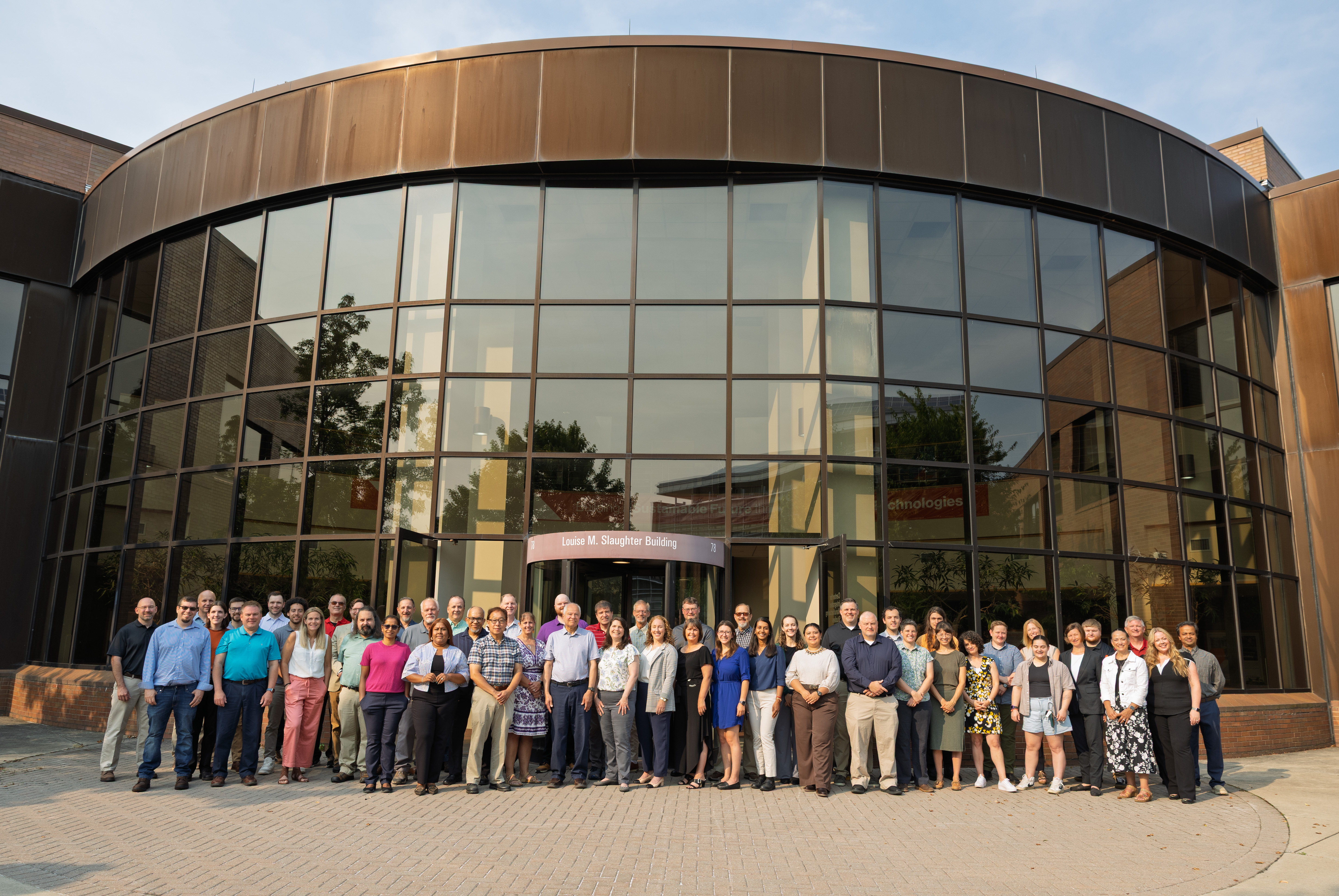 group photo of CIMS staff in front of building entrance