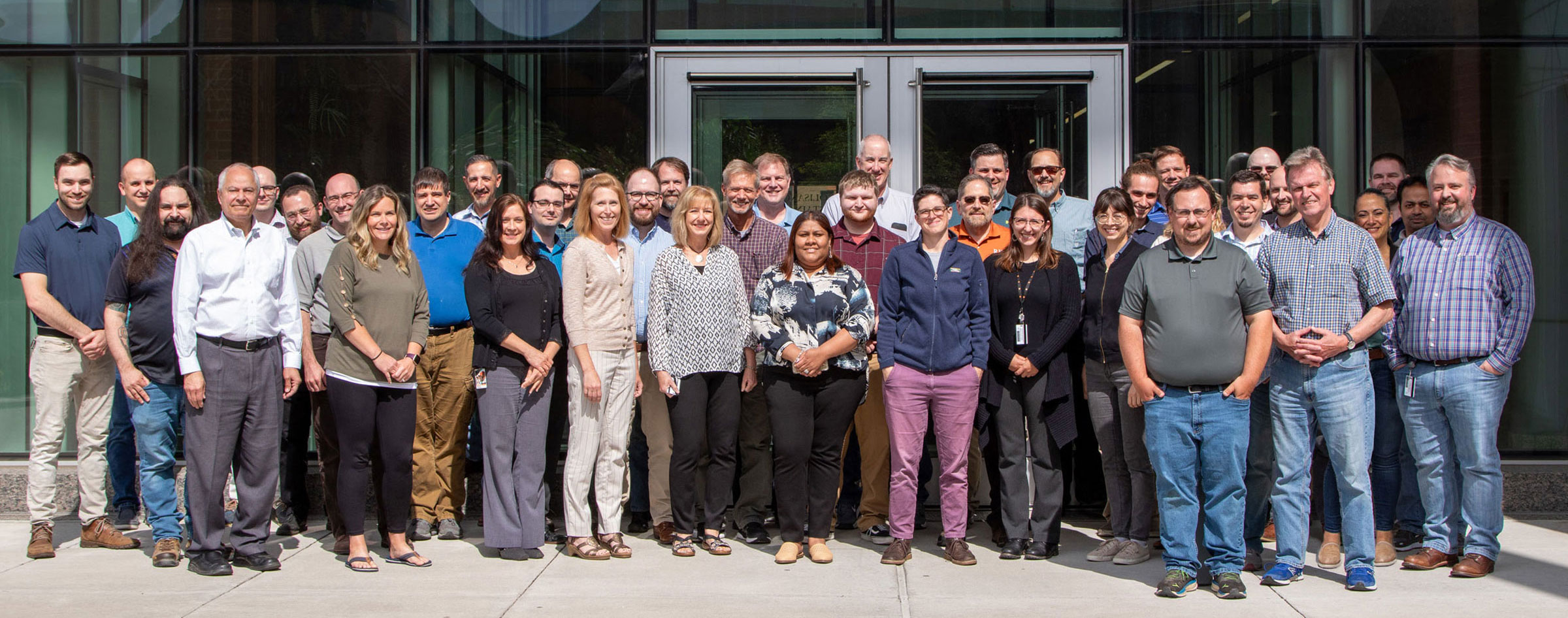 group photo of CIMS staff in front of building entrance