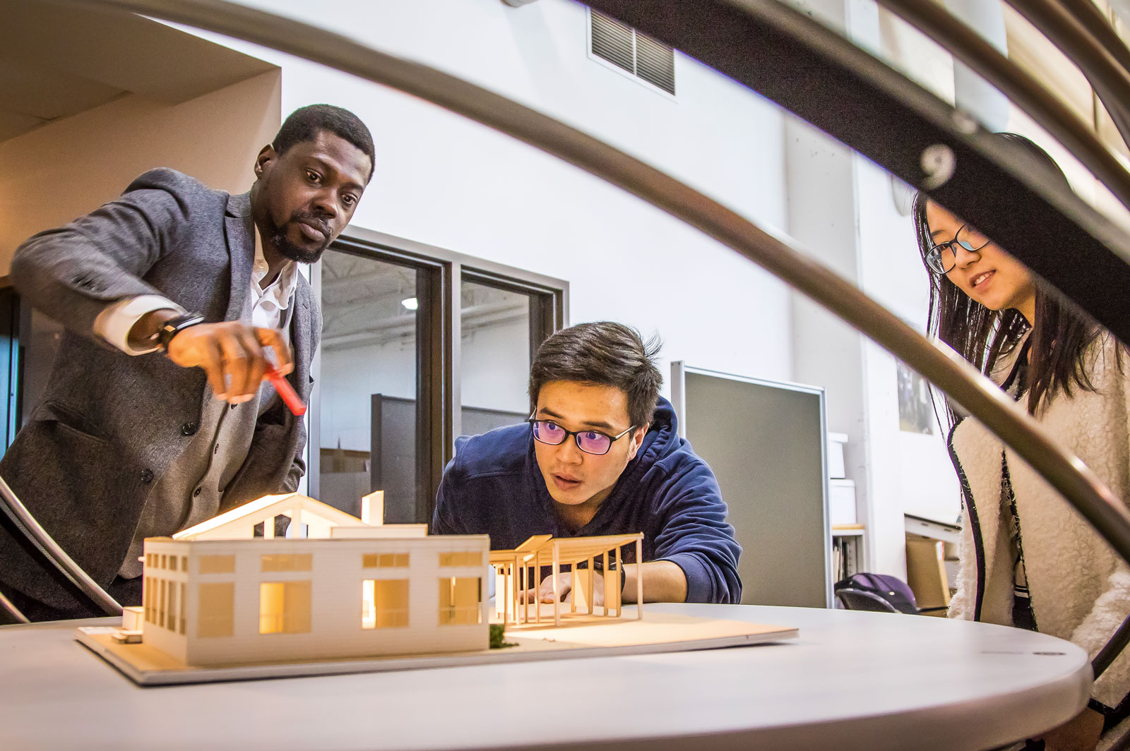 architecture students with building model